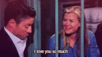 a man and a woman are behind bars and the woman is saying i love you so much .