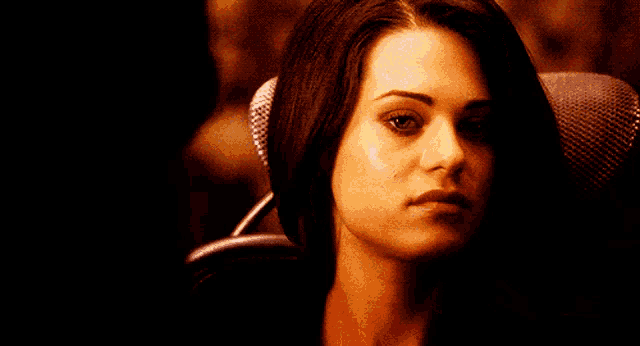 a close up of a woman 's face with dark hair