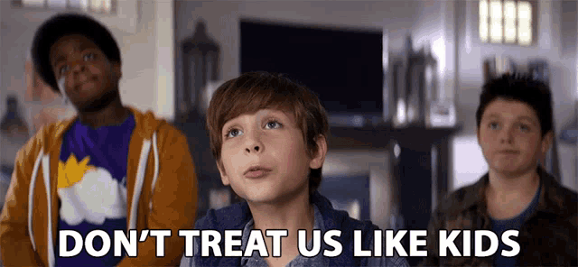 a group of young boys are sitting in front of a television with the words " don 't treat us like kids " above them
