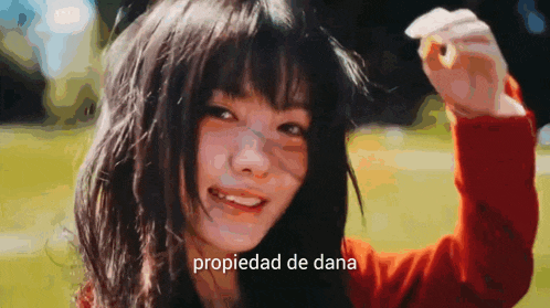 a close up of a woman 's face with the words propiedad de dana written below her