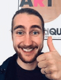 a smiling man with a beard is giving a thumbs up .