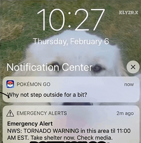 a phone screen shows a notification from the notification center about an emergency alert