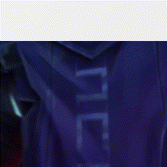 a person wearing a blue hoodie and a hat with glowing eyes is standing next to another person in a dark room .