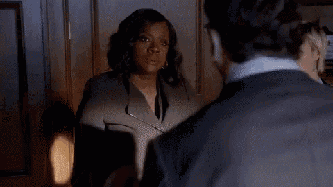 a man and woman are having a fight in a room .