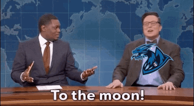 a man sitting at a desk with the words " to the moon " on the bottom