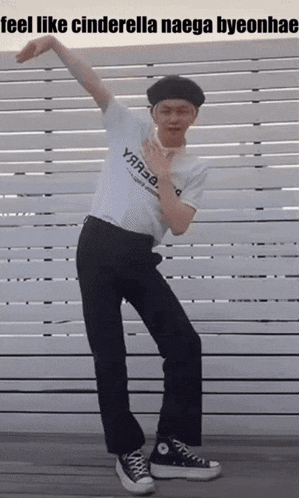 a man is dancing in front of a white fence with the caption feel like cinderella naega byeonhae .