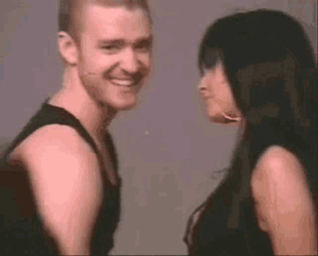 a man and a woman are looking at each other .