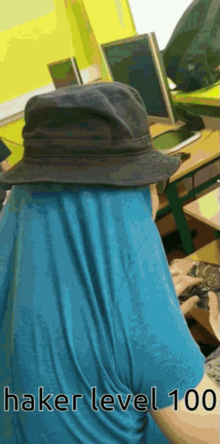 a person wearing a hat and a blue shirt with the words hacker level 100 below them