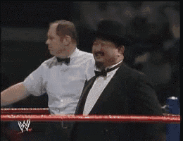 a man in a tuxedo is standing in a wrestling ring with the name mr. fuji on the bottom