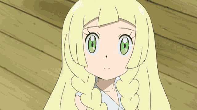a little girl with blonde hair and green eyes
