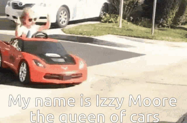 a child is driving a red toy car with the words " my name is izzy moore the queen of cars " written on the bottom