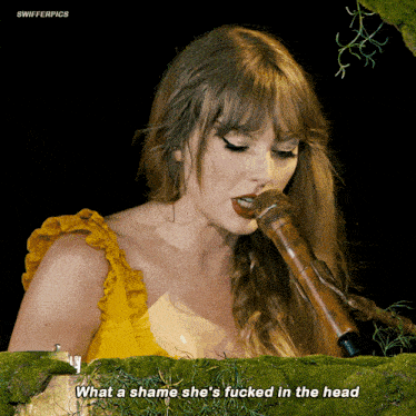 a woman singing into a microphone with the words what a shame she 's fucked in the head above her