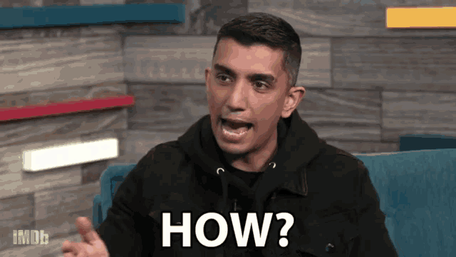 a man is sitting on a blue couch and says how