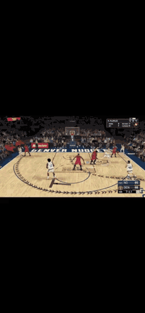 a basketball game is being played on a court with a scoreboard that says espn on it