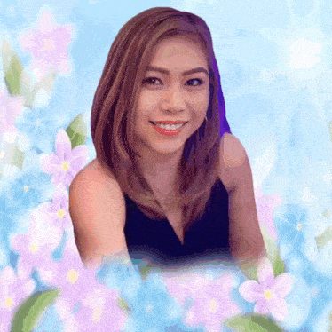 a woman in a black dress is smiling in front of purple flowers