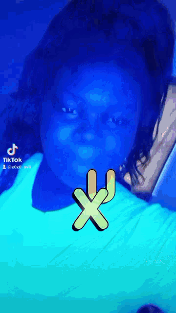 a tik tok video of a girl with a x on her face