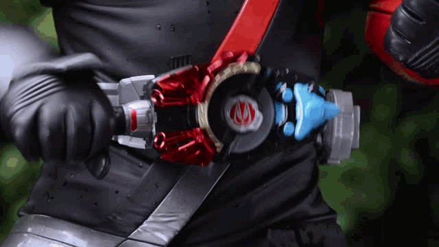 a person wearing a black shirt and a red belt with a red circle on it