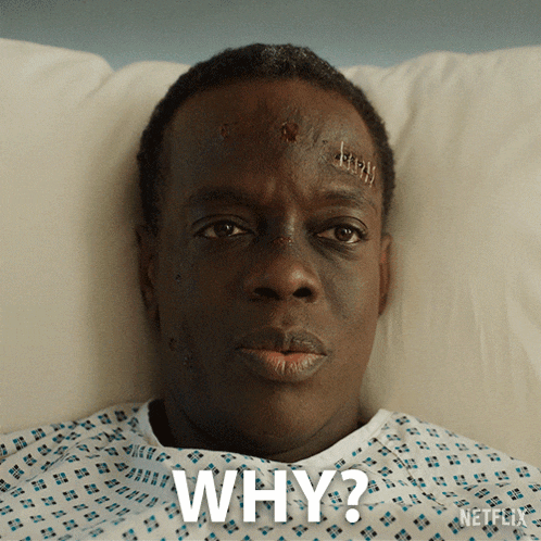 a man in a hospital gown is laying in bed and asking why