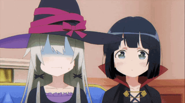 two anime girls are standing next to each other one wearing a witch hat and one wearing a vampire costume