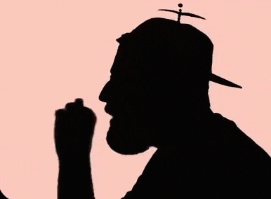 a silhouette of a man with a beard wearing a hat with a propeller on top .