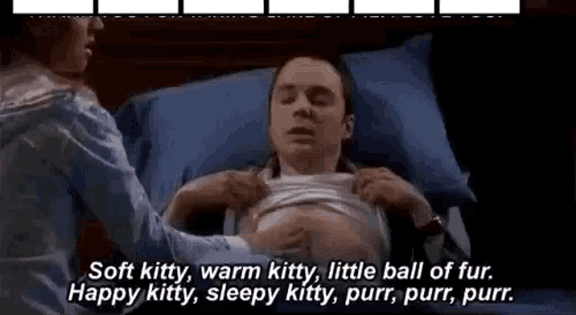 a man is laying in a bed with a woman holding his chest and talking to him .