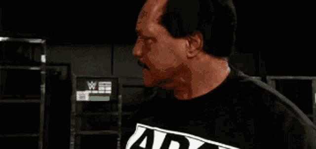 a man in a black shirt with the word damn in white letters