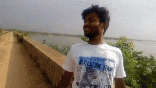 Guy With Printed Shirt Walking GIF - Guy With Printed Shirt Walking Hand Gesture GIFs