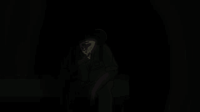 a man in a green suit is standing in the dark