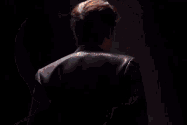 a close up of a man 's face with the sun shining through his hair