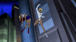 two female superheroes are flying through the air and one has the letter l on her outfit