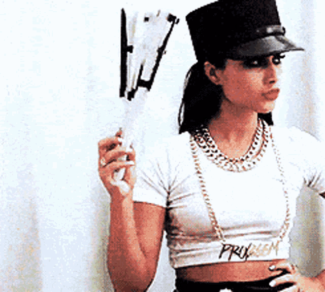 a woman wearing a hat and a necklace with the word preview on the waist