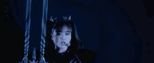 a girl is hanging from a rope in the dark .