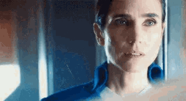 a close up of a woman 's face looking at the camera .