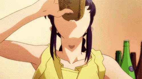 a woman in a yellow top is drinking from a can