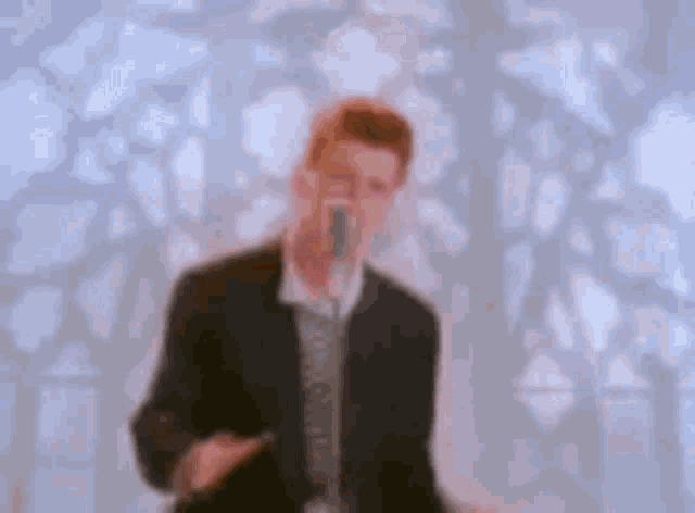 a man in a suit and tie is dancing in front of a mirror .