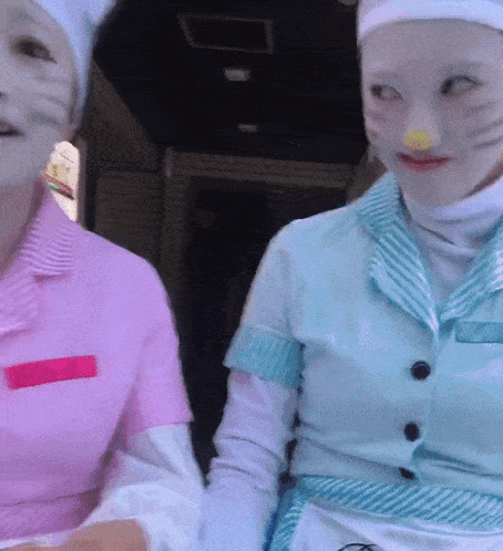 a woman in a hello kitty costume stands next to another woman in a pink shirt