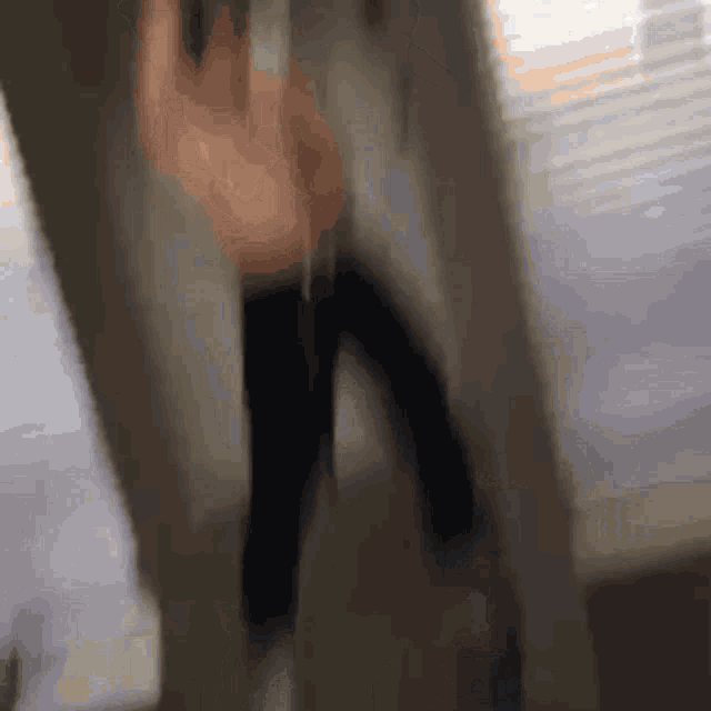 a blurred image of a person standing in a room