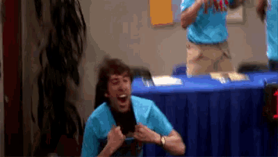 a man wearing a blue shirt that says pns
