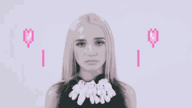 a woman wearing a necklace with teddy bears on it is surrounded by pixelated hearts .