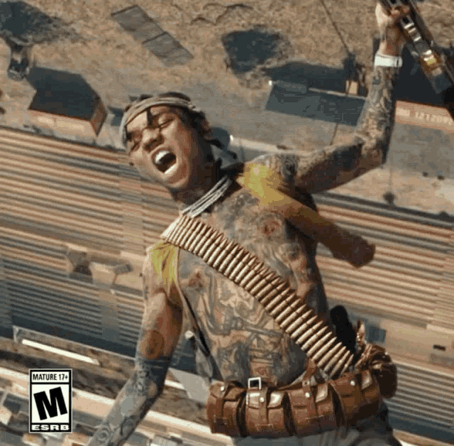 a man with a tattooed body is holding a gun and has the letter m on the bottom left