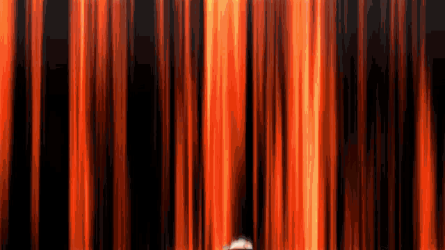 a red curtain is being pulled up on a stage