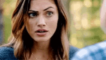 a close up of a woman 's face looking at a man .