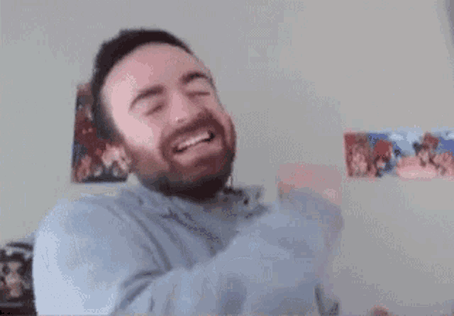 a man with a beard is smiling and the words dang it are behind him