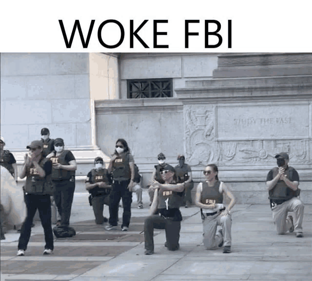 a group of fbi officers are kneeling on the ground