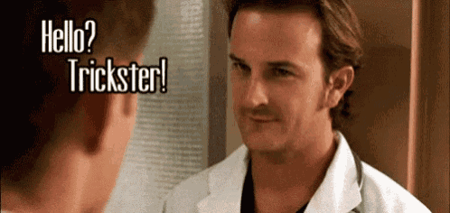 a man in a white coat is talking to another man in a hospital room .