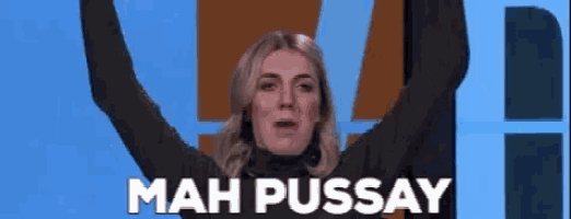 a woman is standing with her arms in the air and the words mah pussay behind her .