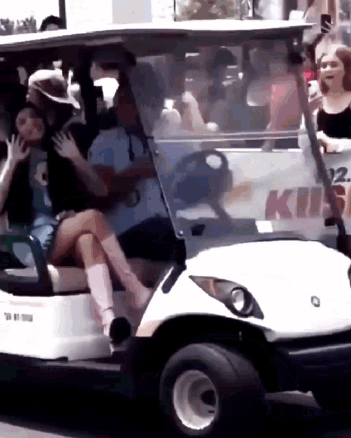 a golf cart with a sign that says kiis