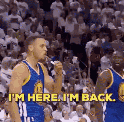 a basketball player is standing in front of a crowd and says `` i 'm here i 'm back ''