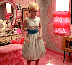 a woman in a white dress is standing in front of a mirror