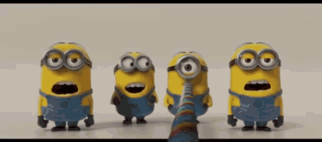 a group of minions are standing next to each other on a table